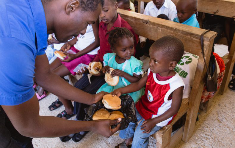 A boy receives some bread